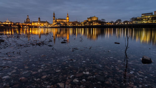 Reflection of illuminated buildings in water at night