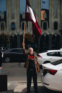 Full length of man standing on street in city