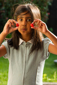 Portrait of young girl with strawberries