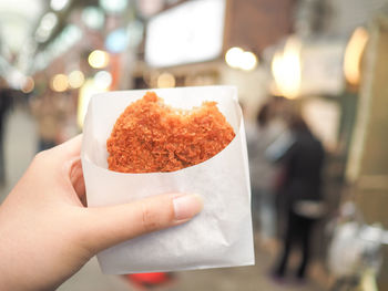 Cropped hand holding of person holding street food