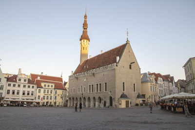 View of buildings in city against clear sky