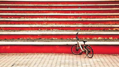 Bicycle parked against wall