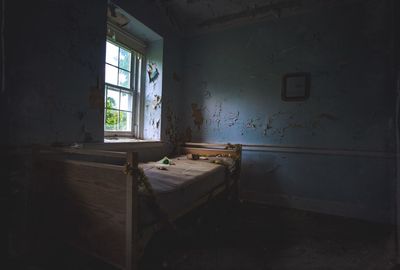 Bed in room at abandoned home