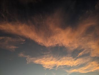 Low angle view of dramatic sky with orange clouds at sunset