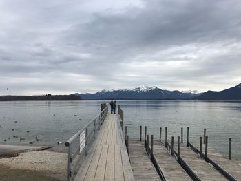 Pier over lake against sky