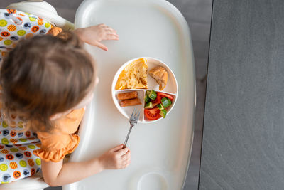 High angle view of cute baby boy eating food