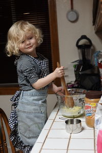 Portrait of smiling girl standing at home