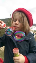 Close-up of girl holding bubbles