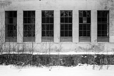 Building seen through window during winter