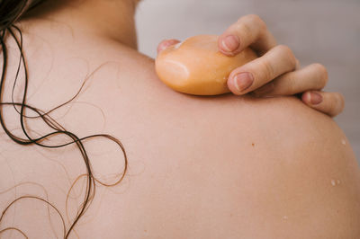 Midsection of woman holding heart shape