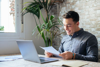 Young man using laptop at office