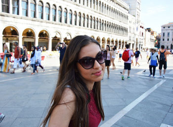 Portrait of young woman at st marks square in city