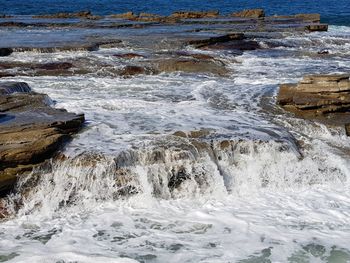 Waves splashing on rocks at shore