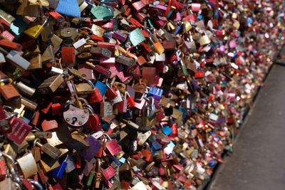 High angle view of padlocks on railing