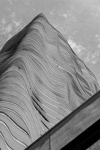 Low angle view of building against cloudy sky
