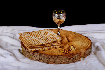 Close-up of wineglass on table against black background