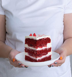 Midsection of woman holding cake