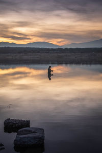 Scenic view of lake against sky during sunset