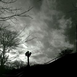 Silhouette trees against cloudy sky