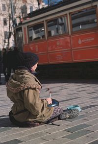 Man sitting in park during winter