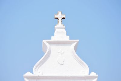 Statue of bell tower against clear blue sky