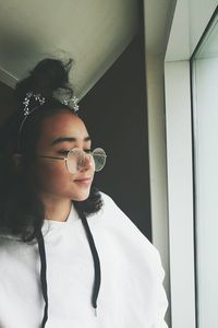 Close-up of girl standing against wall