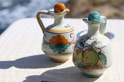 Close-up of decorative jugs on table