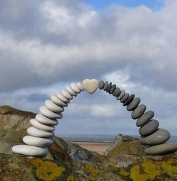 Close-up of stones on shore against sky