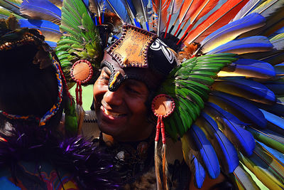 Portrait of woman with multi colored feathers