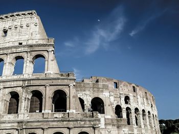 Low angle view of coliseum against sky