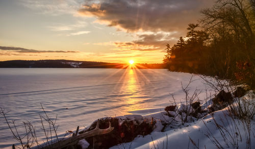 Scenic view of snow against sky during sunset