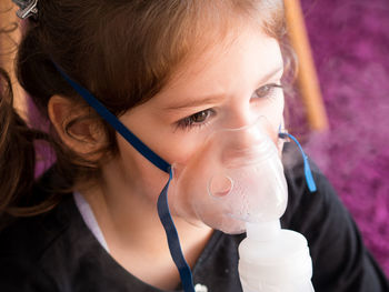 Close-up portrait of a girl drinking water