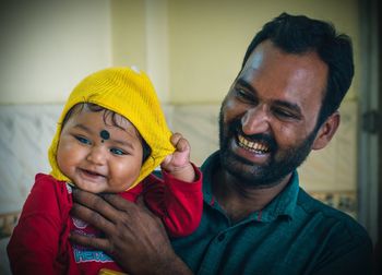 Portrait of smiling boy with baby at home