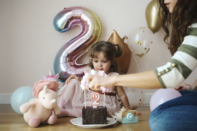 A 2 year old girl celebrating her birthday