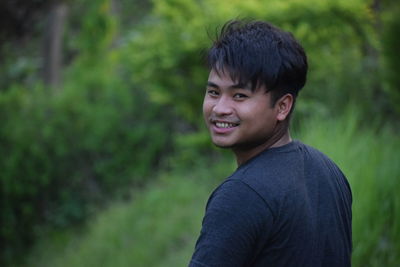 Portrait of young man standing outdoors