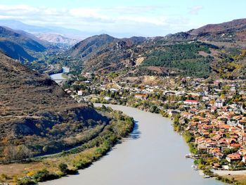 Scenic view of river amidst buildings against sky