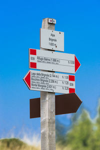 Information sign against clear blue sky