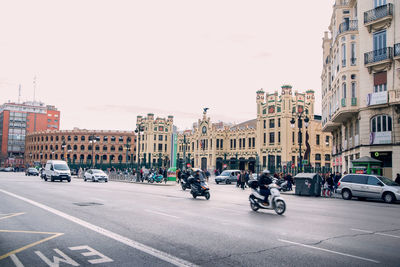 View of city street and buildings against sky