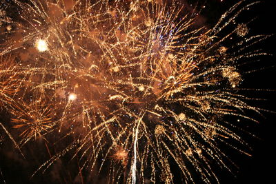 Low angle view of firework display at night
