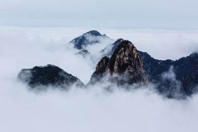 Scenic view of mountains against sky during foggy weather