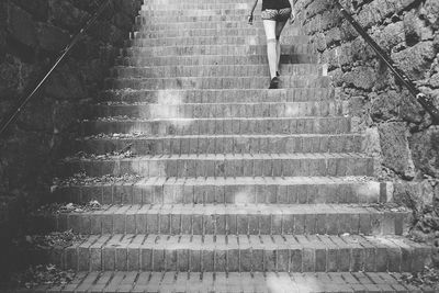 Low section of woman walking on stairs