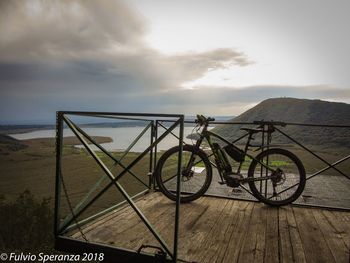 Bicycle on land against sky