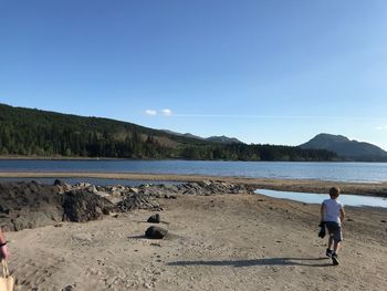 Full length of man on beach against sky