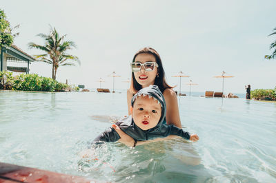 Portrait of mother and son in swimming pool