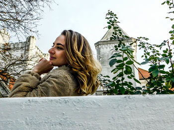 Low angle view of woman against sky during winter