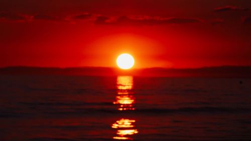 Scenic view of sea against romantic sky at sunset