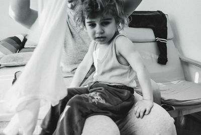 Girl sitting with mother at home