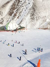 High angle view of people on snow covered mountain