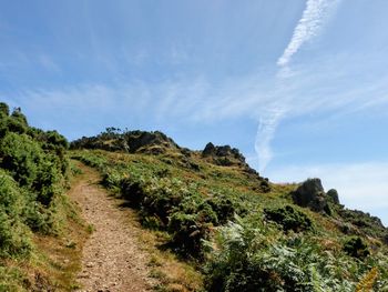 Scenic view of hill against sky