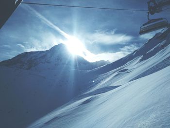 Low angle view of mountain against sky during winter